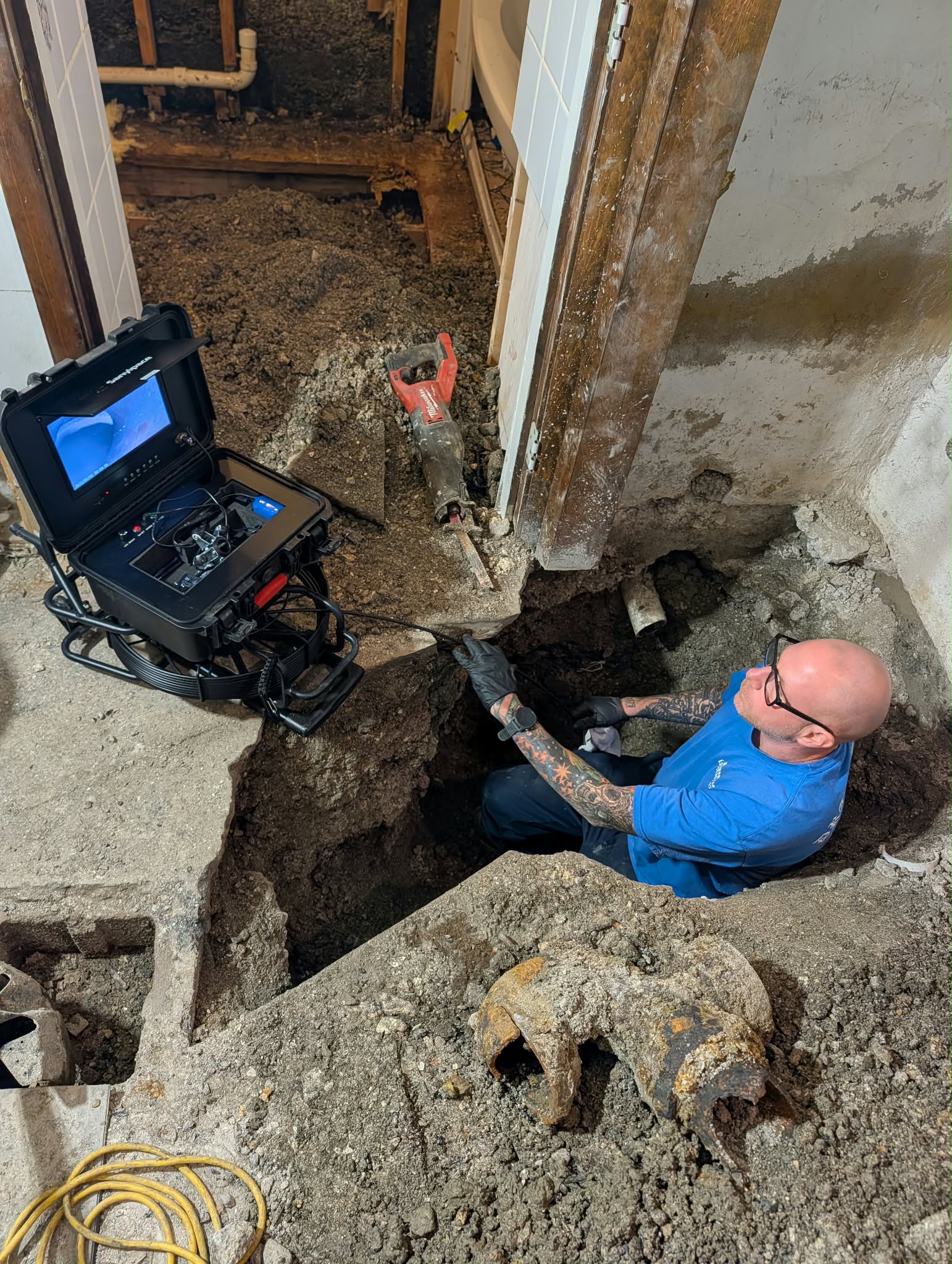 A Drain-Flo technician inspecting an underground pipe with a plumbing camera system